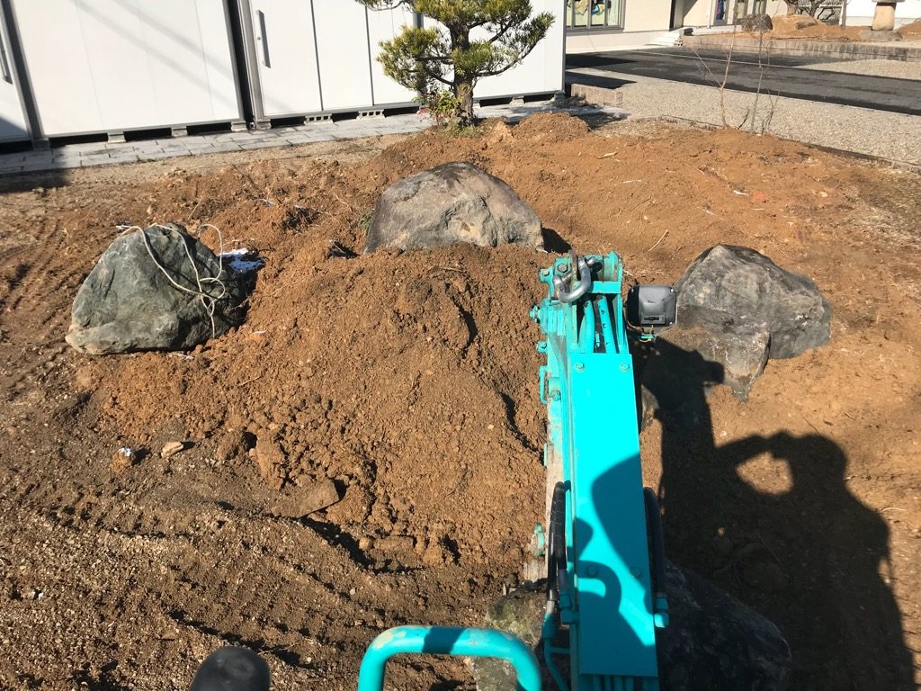 庭石を据えてはいろんな角度からバランスを見て微調整します